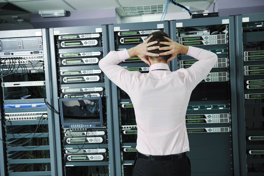 it business man in network server room have problems and looking for disaster situation solution it business man in network server room have problems and looking for disaster situation solution